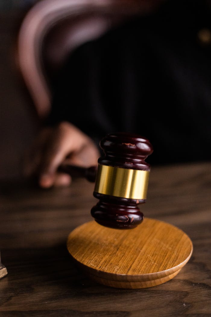 services-01 Close-up of a judge's gavel on a wooden block, symbolizing justice and law.